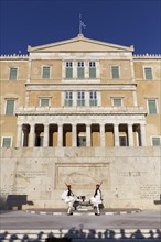 Two Evzones in traditional dress in front of the parliament building, Tomb of the Unknown Soldier,