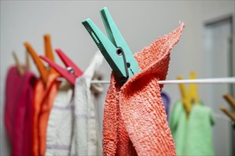 Different colored kitchen towels on a clothesline drying