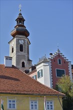 Close-up of a church tower and neighbouring historic buildings under a clear blue sky, St.