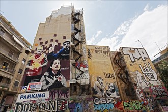 Graffiti-painted house walls, portraits of three Turkish activists who died on hunger strike,