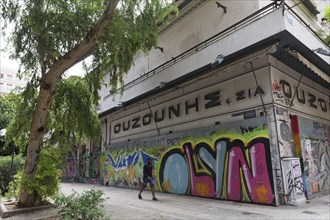 Alley with abandoned shop and graffiti in Exarchia, student and alternative neighbourhood, Athens,