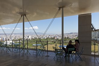 Couple on the panoramic terrace, view of the landscape park and Athens, Cultural Centre of the