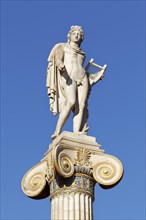 Column with statue of Apollo in front of the Academy of Athens, blue sky, sculptor Leonidas Drosis,