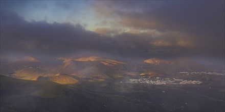 Panorama at sunrise from Montana de Guardilama to the wine-growing region of La Geria, with the