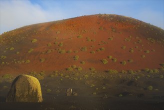 Lava bomb in front of Caldera Colorada, Parque Natural de Los Volcanes, near Masdache, Lanzarote,