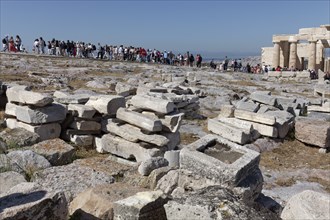 Queue of tourists on the way between Propylaea and Parthenon, in front excavation remains,