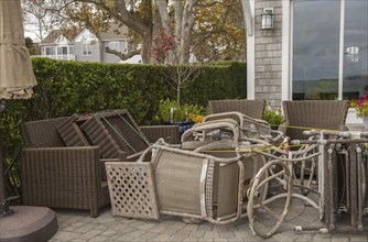 Tied down patio furniture at a house along a Connecticut USA beach for protection against Hurricane