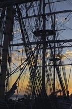 San Diego, California, USA, Sunset seen through the silhouette of the HMS Surprise, a replica of a