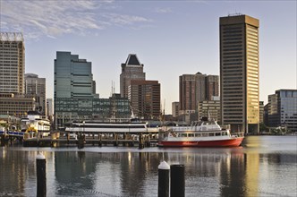 The skyline and boats in the early morning in the inner Harbor, Baltimore Maryland USA