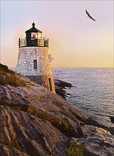 Castle Hill Lighthouse at twilight as the sun sets, overlooking Narragansett Bay, Newport, Rhode