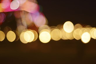 An abstract image featuring blurred lights in circular bokeh patterns with a warm and dreamy