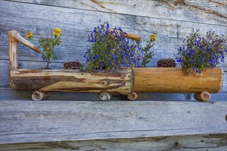 Rustic wooden decoration with flowers on a wooden wall, saas Fee, Alps, Switzerland, Europe