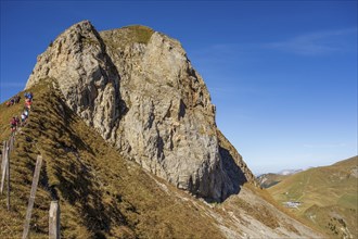 Steep cliff with hikers along a path under a clear sky, saas Fee, Alps, Switzerland, Europe