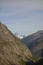 A narrow mountain gorge with snow-capped peaks in the background, Saas Fee, Switzerland, Europe