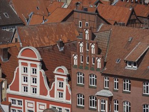 Historic buildings with striking red-brown tiled roofs and windows that characterise an old