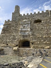 View from the harbour entrance to the sea-side outer wall of a fortress built in the Middle Ages