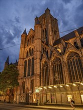 Impressive cathedral at night with dramatic sky and illuminated facades, Ghent, Belgium, Europe