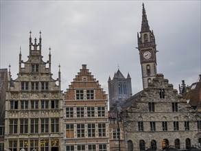 Row of Gothic facades and towers under a grey sky in the city centre, Ghent, Belgium, Europe