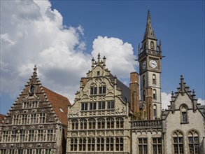 Historic buildings and towers in a Gothic style under a sky with clouds, Ghent, Belgium, Europe