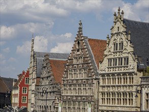 Gabled houses with colourful Gothic-style facades under a blue summer sky, Ghent, Belgium, Europe