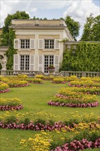 Flower beds in the garden of a historic building with shutters and ivy, Salzburg, Austria, Europe