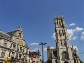 Historic Gothic church building under a blue sky with decorated faÃ§ade and tower, Ghent, Belgium,