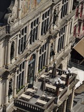 Large balcony of a historic building with chairs, tables and statues, Ghent, Belgium, Europe