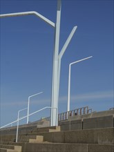 Architectural steps with railings and lamps under a clear sky, scheveningen, the netherlands