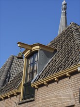 Details of a dormer window and skylight of a brick building under a clear sky, Doesburg,