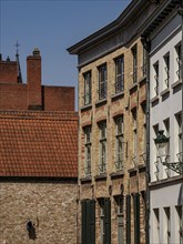 Rows of brick houses and plastered facades under a clear sky, de haan, Belgium, Europe