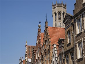 Historic cityscape with striking towers and brick buildings on a sunny day, Bruges, Belgium, Europe