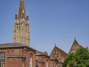 Historic church with high stone towers, framed by a clear summer sky, Bruges, Belgium, Europe
