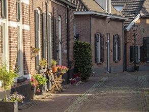 Individual alleyway with lovingly decorated windows and doors, flower pots and a cosy atmosphere in