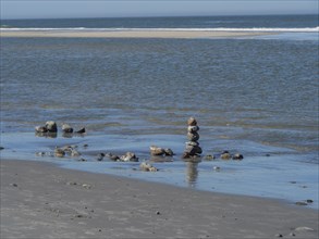 Cairns on the beach, view of the sea and the horizon in a peaceful atmosphere, langeoog, germany