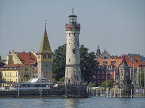 Lighthouse and historic buildings on the lakeshore in a town, Lindau, Lake Constance, Germany,