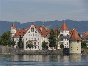 Close-up of a castle with red roofs and white walls on the lake, Lindau, Lake Constance, Germany,