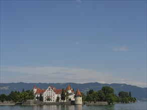 A castle on an island in the lake with mountains and blue sky in the background, Lindau, Lake