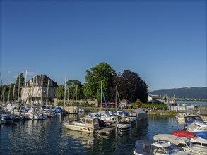 Harbour view with many boats in front of buildings on a clear summer day, Lindau, Bavaria, Germany,