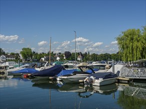 A peaceful harbour with numerous boats on the shore under a clear sky, Lindau, Bavaria, Germany,