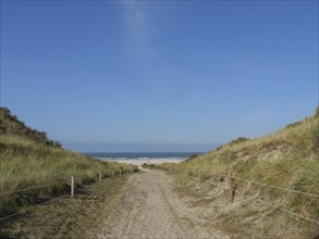 Path leads through dunes to the sea, quiet atmosphere, blue sky, juist, east frisia, germany