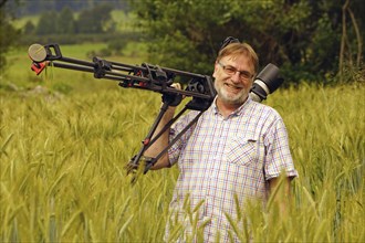 Cameraman at work in a wheat field