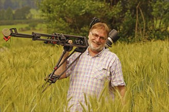 Cameraman at work in a wheat field