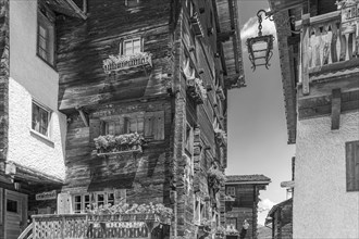 Old wooden houses in the historic centre of Grimentz, black and white photo, Val d'Anniviers,