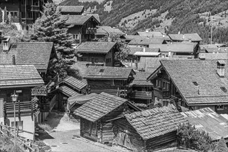 Old wooden houses with wooden shingle roofs, historic centre of Grimentz, black and white photo,