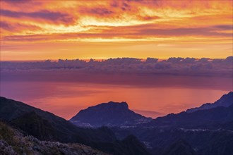 Pico do Arieiro at Sunrise. Fiery Clouds on Sky, Mountains and Atlantic Ocean. Madeira, Portugal,