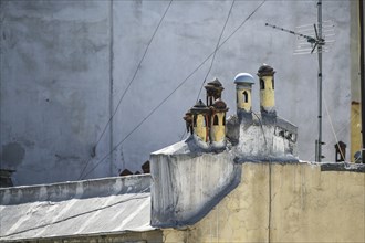 Small Mediterranean chimney pots with different caps looking like a miniature village on the