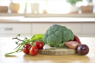 Broccoli and other fresh vegetables on a wooden worktop, preparation for healthy cooking, the