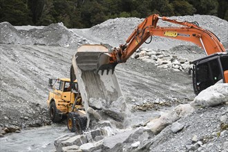 OTIRA, NEW ZEALAND, SEPTEMBER 19, 2019: A tip truck dumps a load of rock to create flood water