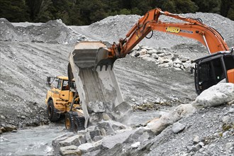 OTIRA, NEW ZEALAND, SEPTEMBER 19, 2019: A tip truck dumps a load of rock to create flood water