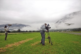 Cameraman and sound technician at work on location